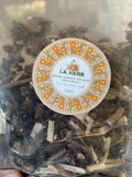 Original LA Herb supplier package labeled Siberian cocklebur herb whole, Xanthium sibiricum, showing dried burs and stems.
